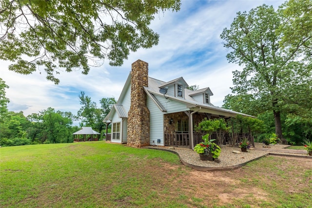 view of home's exterior featuring a gazebo and a lawn