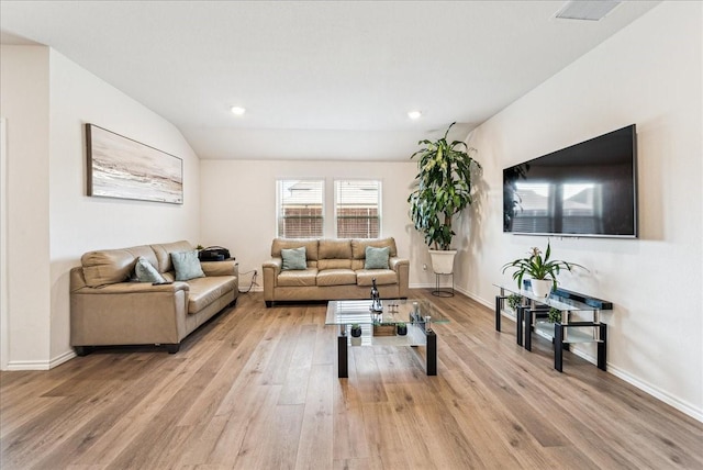 living area with baseboards, recessed lighting, and light wood-style flooring