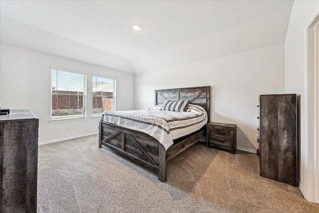 bedroom with carpet floors, baseboards, and vaulted ceiling