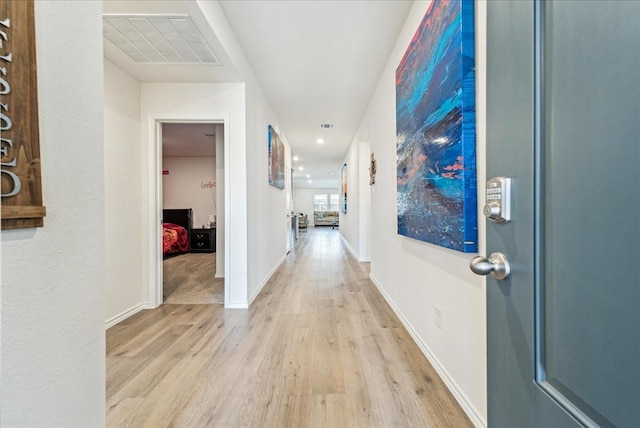 hallway featuring visible vents, recessed lighting, light wood-style floors, and baseboards