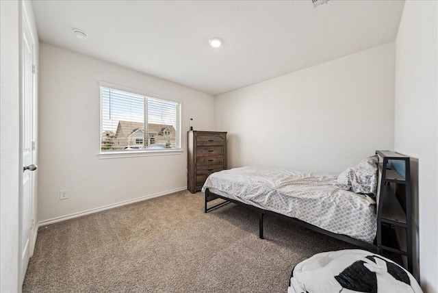 carpeted bedroom featuring baseboards