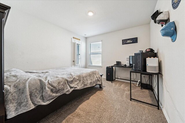 carpeted bedroom featuring baseboards