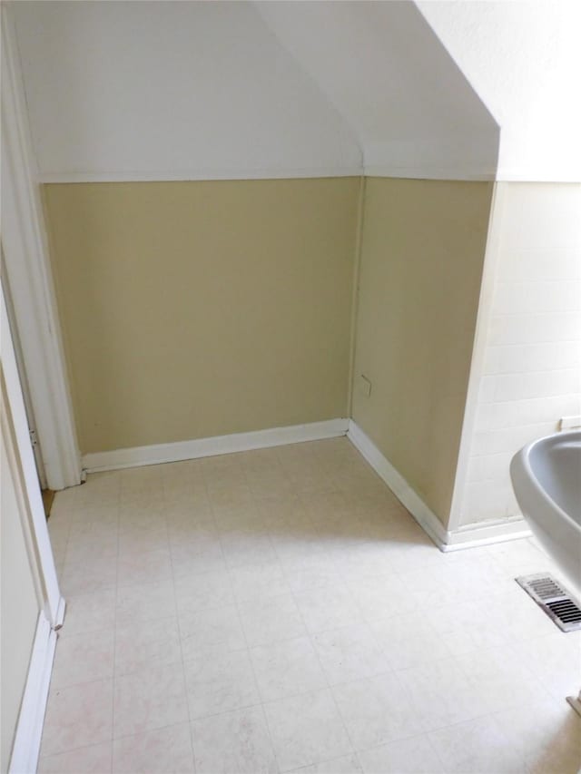 bathroom featuring lofted ceiling