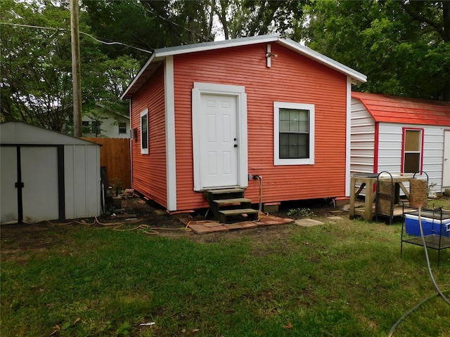 view of outbuilding with a yard