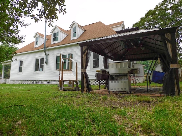 back of house with a gazebo and a yard