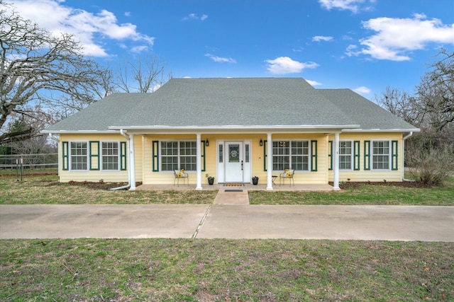 view of front of house with a porch and a front yard