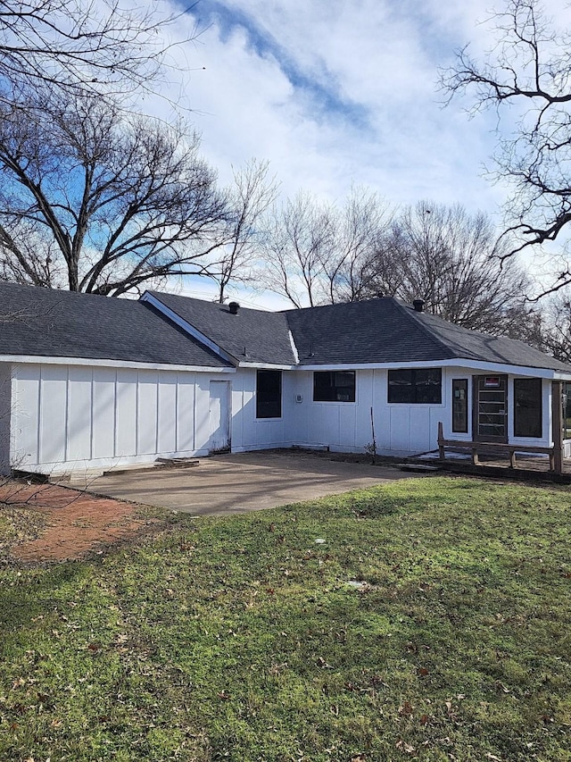 back of property featuring a yard and a patio area