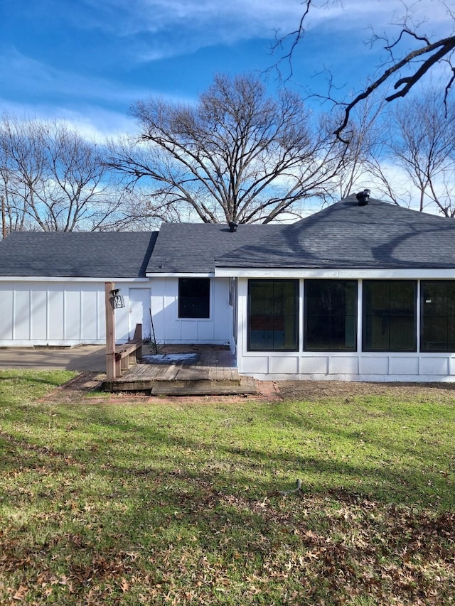 back of house with a lawn and a deck