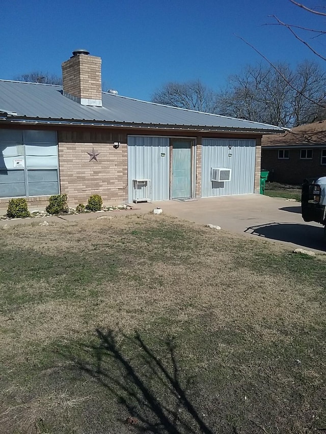 rear view of property with a lawn and a patio