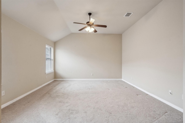 unfurnished room featuring ceiling fan, lofted ceiling, and carpet flooring