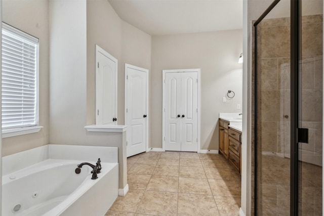 bathroom with vanity, tile patterned floors, and plus walk in shower