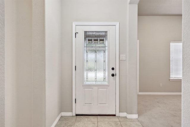 entrance foyer featuring light tile patterned flooring and plenty of natural light