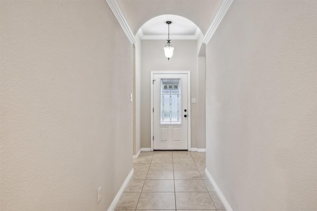 entryway featuring crown molding and light tile patterned flooring