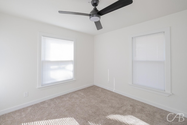 carpeted spare room with ceiling fan