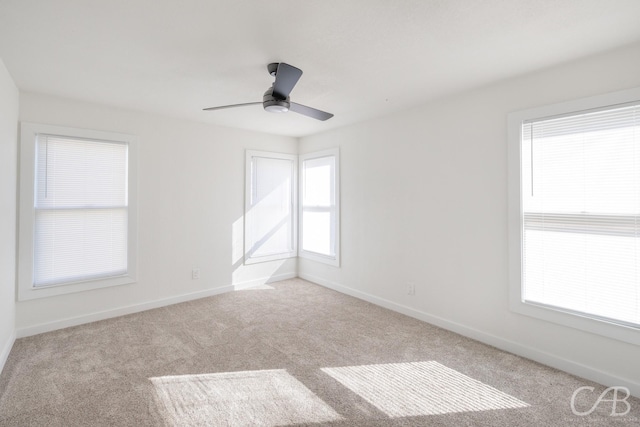 carpeted spare room with ceiling fan