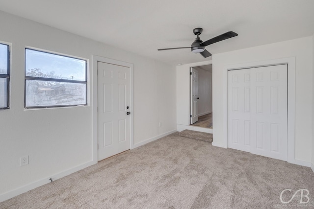 unfurnished bedroom featuring light colored carpet and ceiling fan