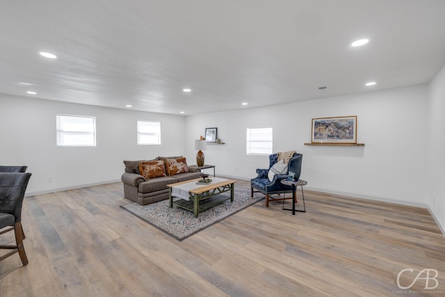 living room with a wealth of natural light and light wood-type flooring