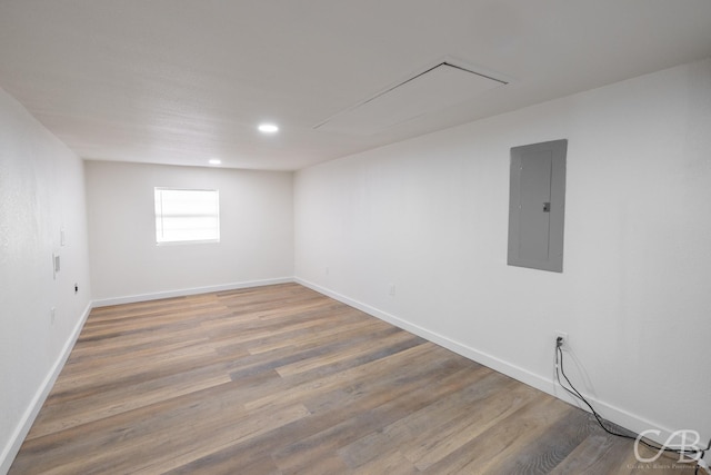 spare room with hardwood / wood-style flooring and electric panel