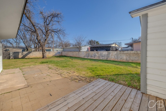 deck with a patio and a lawn