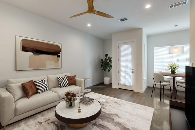 living room with hardwood / wood-style flooring and ceiling fan