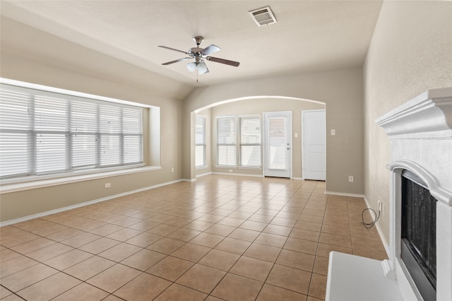 unfurnished living room with light tile patterned flooring, lofted ceiling, and ceiling fan