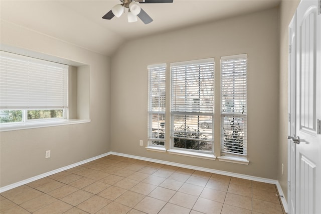 tiled empty room with lofted ceiling and ceiling fan