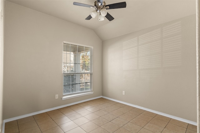 spare room featuring ceiling fan, vaulted ceiling, and light tile patterned floors