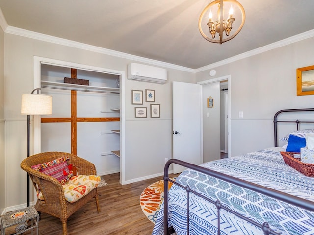 bedroom with hardwood / wood-style floors, a wall mounted air conditioner, ornamental molding, a notable chandelier, and a closet