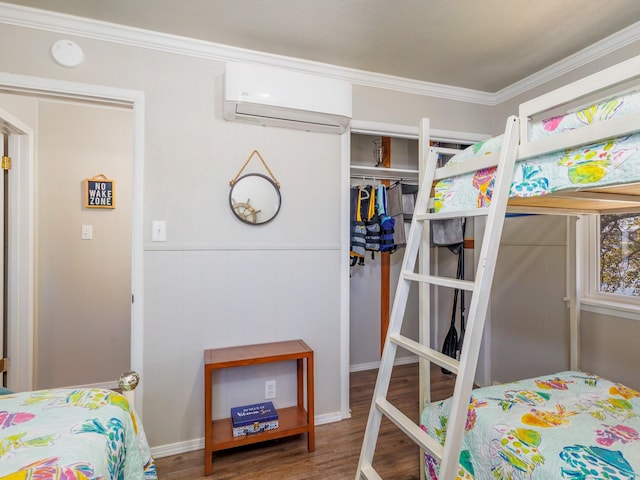 bedroom featuring hardwood / wood-style flooring, ornamental molding, and an AC wall unit