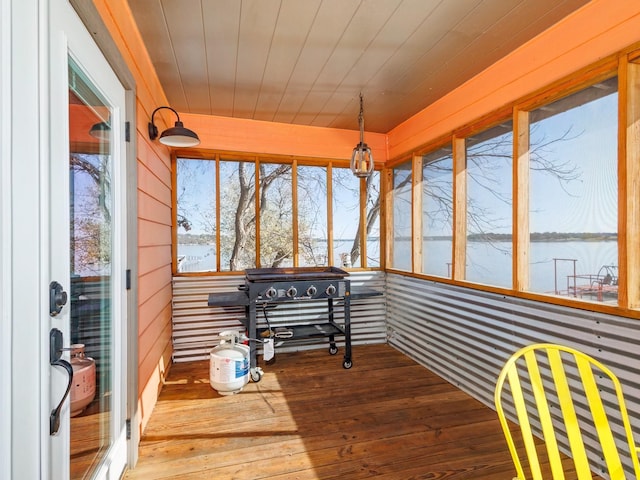 sunroom / solarium with a water view and wood ceiling