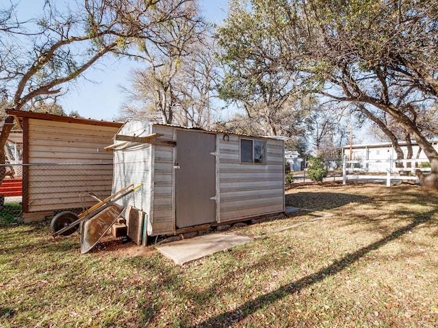 view of outbuilding featuring a lawn