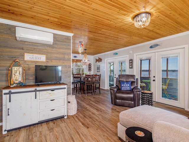 living room featuring an AC wall unit, wooden ceiling, french doors, and a chandelier