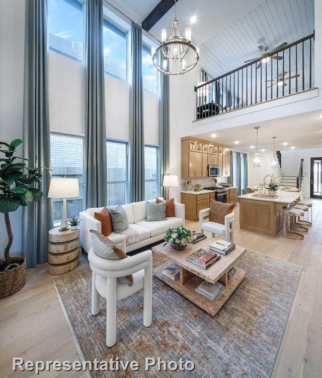 1250 Falls Rush Way, Royse City, TX 75189 - living room with floor to ceiling windows, a healthy amount of sunlight, a notable chandelier, and light hardwood / wood-style floors