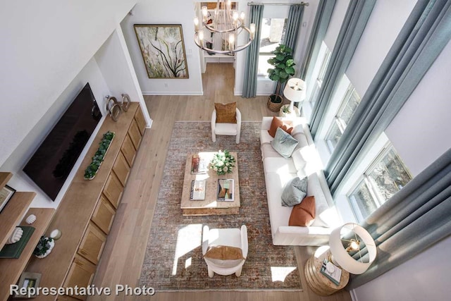 1250 Falls Rush Way, Royse City, TX 75189 - living room with a notable chandelier and wood-type flooring