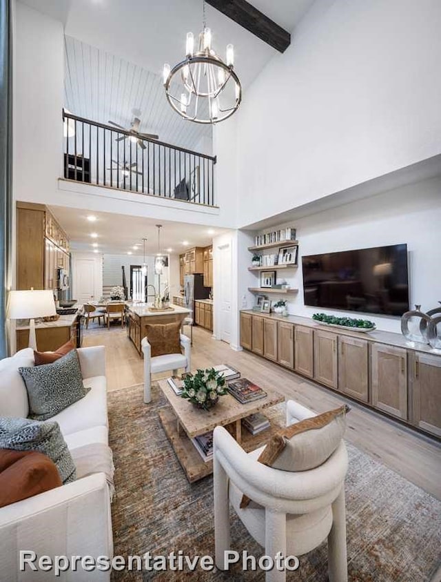 1250 Falls Rush Way, Royse City, TX 75189 - living room with beam ceiling, a high ceiling, a chandelier, and light hardwood / wood-style floors