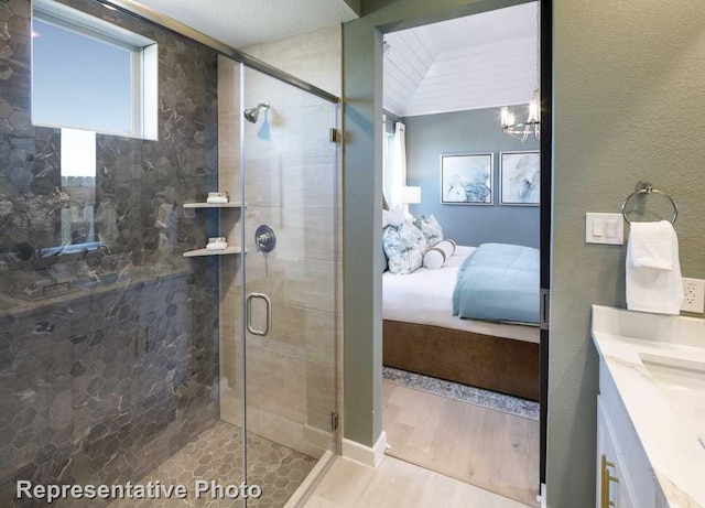 1250 Falls Rush Way, Royse City, TX 75189 - bathroom with a notable chandelier, vanity, wood-type flooring, and an enclosed shower