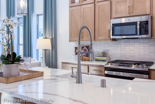 1250 Falls Rush Way, Royse City, TX 75189 - kitchen with stainless steel appliances, light stone countertops, and decorative backsplash