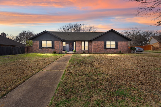 ranch-style house featuring a lawn