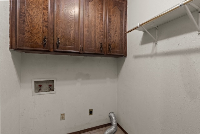 clothes washing area featuring electric dryer hookup, washer hookup, and cabinets