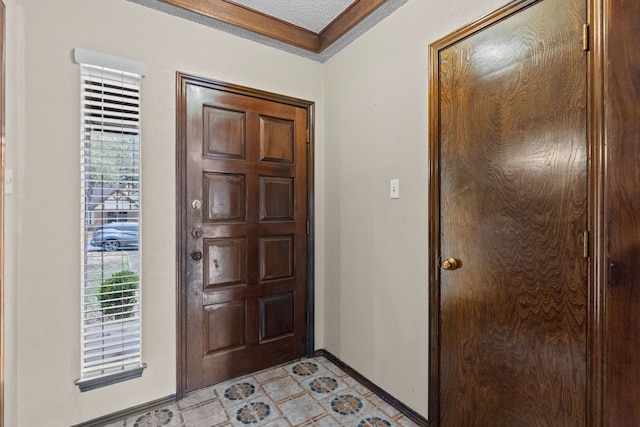 foyer featuring ornamental molding and a textured ceiling