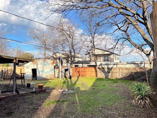 view of yard with an outbuilding, fence, and a shed