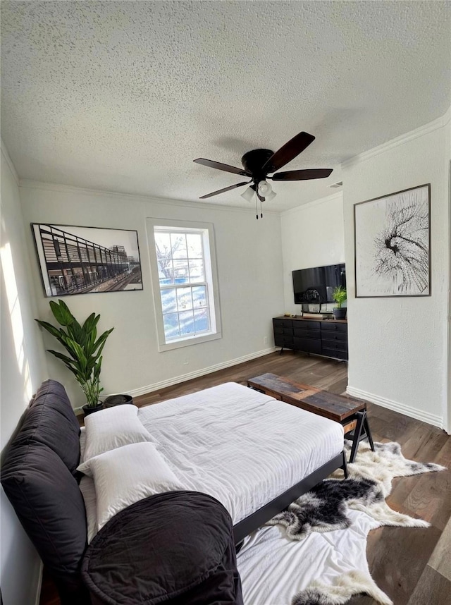 304 Lockwood St, White Settlement, TX 76108 - bedroom featuring dark wood-style floors, a textured ceiling, a ceiling fan, crown molding, and baseboards