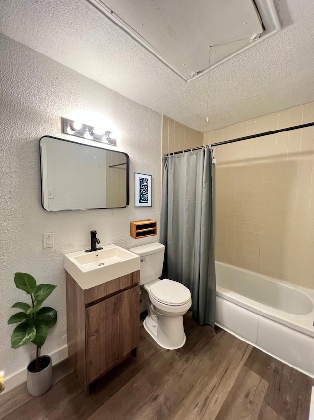 304 Lockwood St, White Settlement, TX 76108 - bathroom with wood finished floors, toilet, a textured wall, vanity, and a textured ceiling