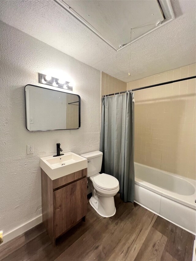 304 Lockwood St, White Settlement, TX 76108 - bathroom featuring a textured wall, wood finished floors, toilet, vanity, and a textured ceiling