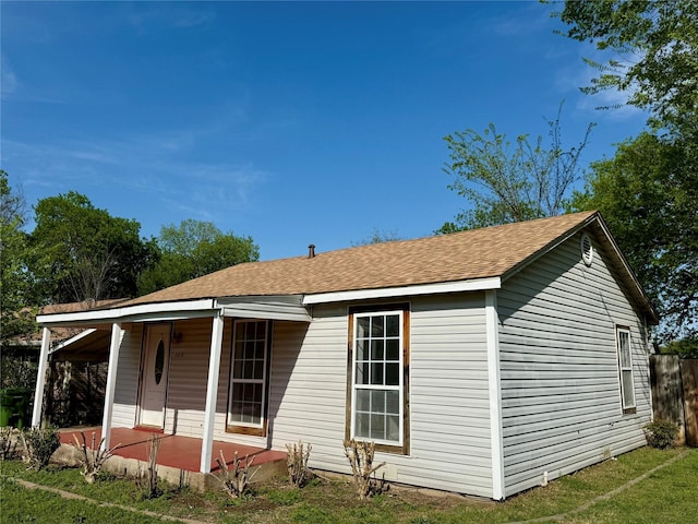 view of front of home featuring covered porch and roof with shingles