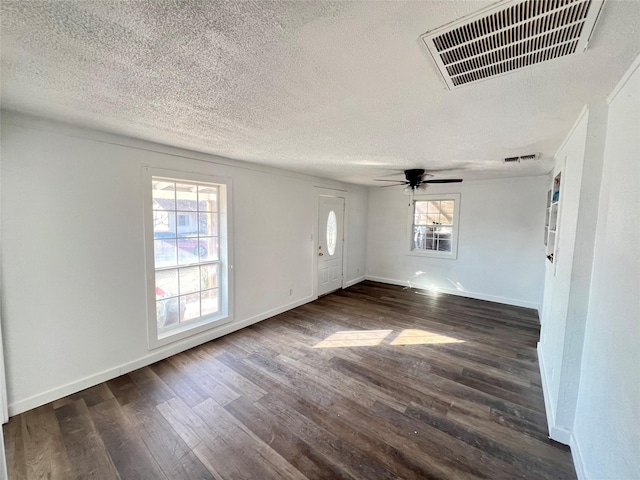 interior space with ceiling fan, dark hardwood / wood-style floors, and a textured ceiling