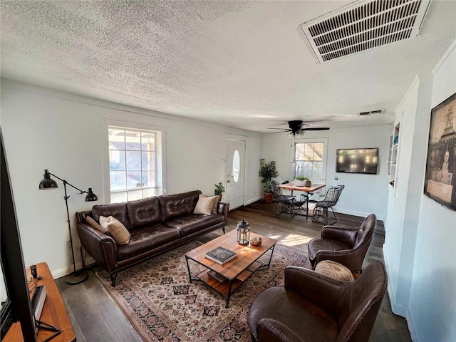 304 Lockwood St, White Settlement, TX 76108 - living area featuring a textured ceiling, wood finished floors, a ceiling fan, and baseboards