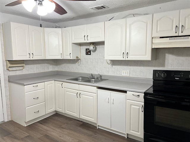 kitchen featuring dark wood-style flooring, a ceiling fan, under cabinet range hood, black electric range oven, and a sink