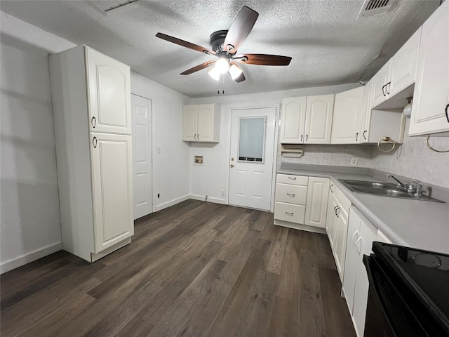 kitchen featuring ceiling fan, white cabinetry, a sink, electric range oven, and dark wood-style floors