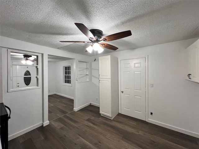 304 Lockwood St, White Settlement, TX 76108 - unfurnished bedroom with dark wood-type flooring, baseboards, a textured ceiling, and a ceiling fan